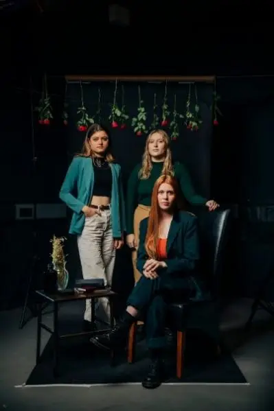 3 female cast members looking forwards