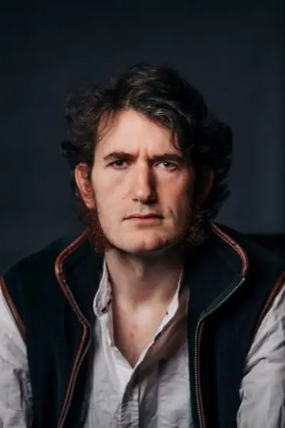 A close up of a male cast member